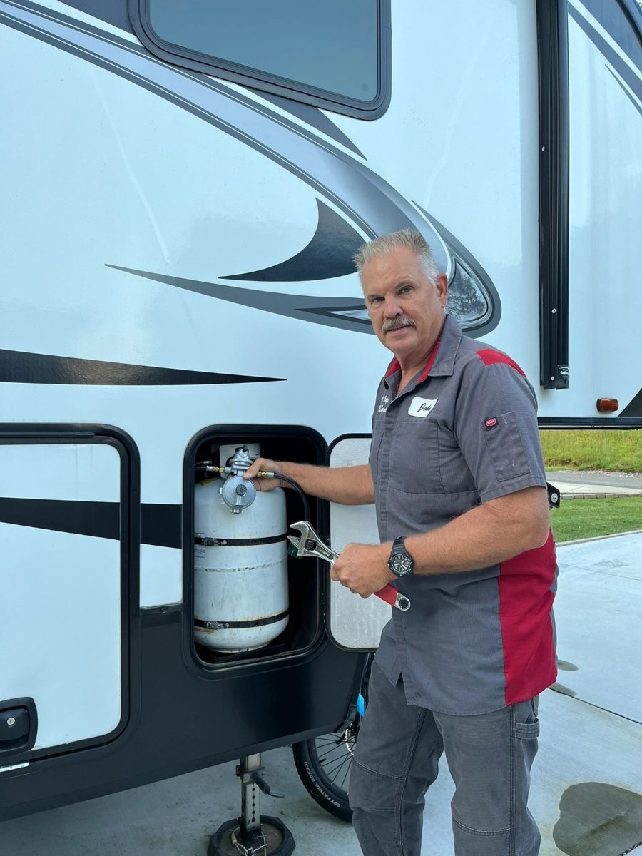 John of Mr. Rogers RV Repair servicing an RV propane system