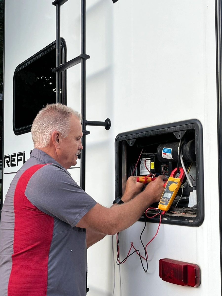 John diagnosing an RV refrigerator with a professional meter
